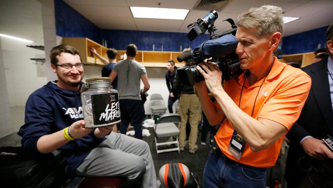 Student manager Alex Poedtke shows off the team's "urn" holding the ashes of the team's February calendar in the locker room a practice session ahead of the NCAA Tournament Sweet 16 matchup between the Xavier Musketeers and the Arizona Wildcats at the SAP Center in San Jose, Calif., on Wednesday, March 22, 2017.