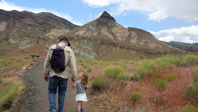 Lucy Urness and Matt Achor hike the overlook trail outside the Thomas Condon Paleontology Center.