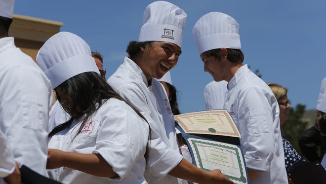 Anthony Morales shows off his certificate after graduating from t he Rancho Cielo Youth Academy's Drummond Culinary Academy on Thursday morning.