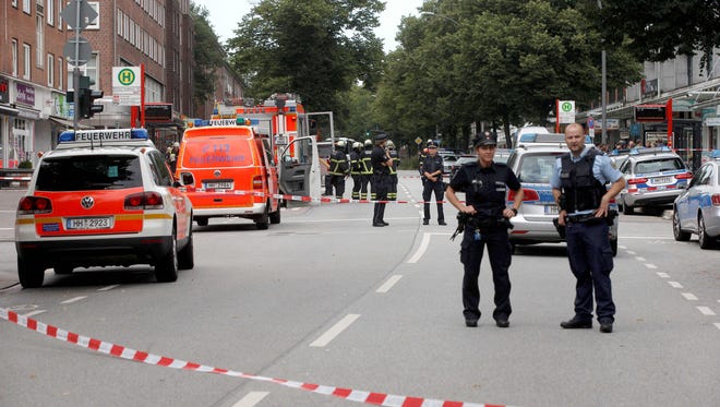 Police cordon off the area around a supermarket in the northern German city of Hamburg, where a man killed one person and wounded several others in a knife attack on July 28, 2017.