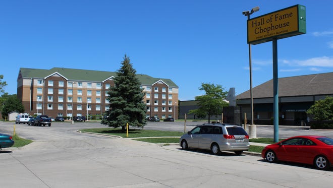 The Hilton Garden Inn has filed a lawsuit seeking to stop construction of a Staybridge Suites hotel on the property between the Hilton, left, and the Hall of Fame Chophouse in Green Bay.