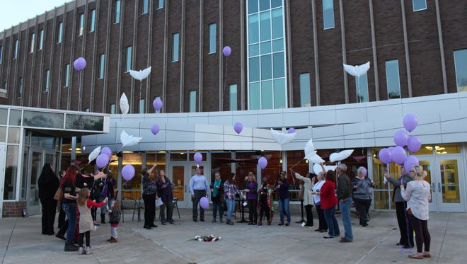 Balloons are released during a candlelight vigil on Thursday, Oct. 19, 2017. October is Domestic Violence Awareness Month.