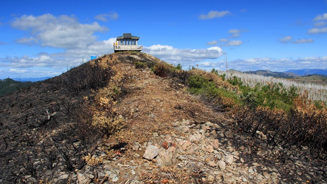 Snow Camp Lookout offers views of the 2017 Chetco Bar Fire on the left (black) and the scar from the 2002 Biscuit Fire on the right (green and white).