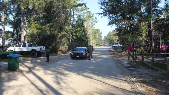 Wakulla County Sheriff's officials canvass a residential neighborhood off Rehwinkel Road in Crawfordville in the manhunt for three inmates who escaped from the county jail Friday morning.