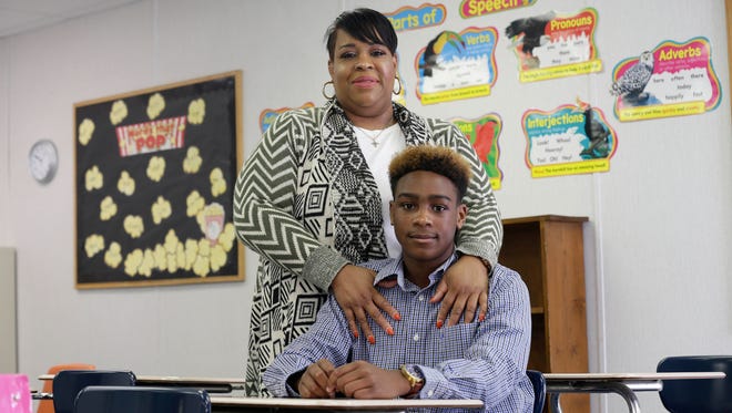 Charlonda Brown stands in a classroom at Wayne Christian School in Goldsboro with her 14 year-old son Amoree' who receives a taxpayer-funded scholarship to attend the private school.  North Carolina was hardly the first state to approve taxpayer-funded scholarships and grants for children to attend private schools, but it’s becoming one of the most prolific.