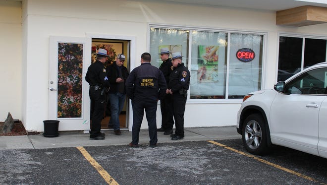 Authorities stand outside Your Green Spa on Route 9 in Wappinger.