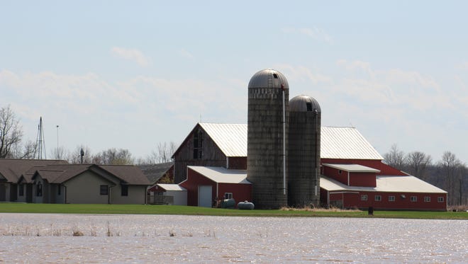 Flooded fields surround this farm in Calumet County last week.