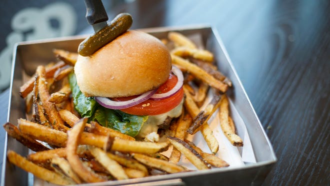 A burger with a side of truffle fries at Frenchie Fresh in Norwood.