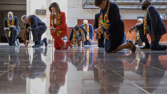 House Speaker Nancy Pelosi of Calif., center, and other members of Congress, kneel and observe a moment of silence at the Capitol's Emancipation Hall, Monday, June 8, 2020, on Capitol Hill in Washington, reading the names of George Floyd and others killed during police interactions. Democrats proposed a sweeping overhaul of police oversight and procedures Monday, an ambitious legislative response to the mass protests denouncing the deaths of black Americans at the hands of law enforcement.