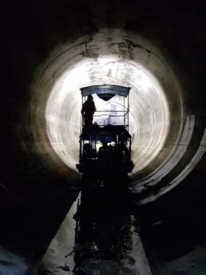 A three-man crew on 8-wheeled vehicle drove into the Northwest Side deep tunnel in December to begin inspection of the 20-foot-in-diameter cavern.