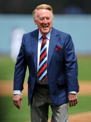 Vin Scully reacts after throwing out the first pitch before the 2009 Opening Day game against the Giants at Dodger Stadium.