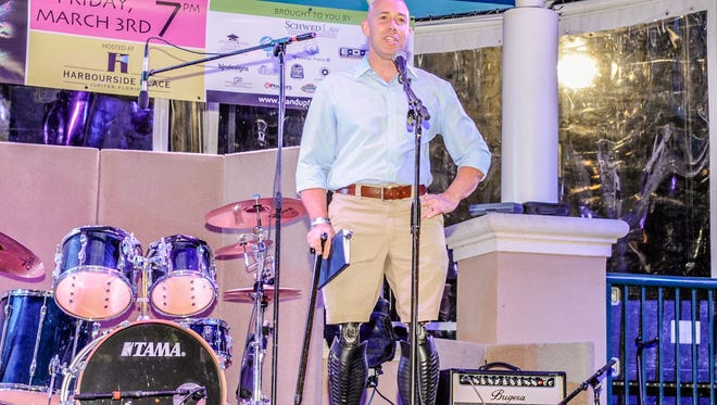 Florida U.S. Rep. Brian Mast addresses the crowd at Neon Nights, held recently at Harbourside Place in Jupiter.