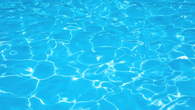 Blue water rippled background in swimming pool.