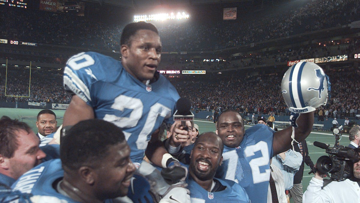 Detroit Lions running back Barry Sanders is carried on the shoulders of teammates after reaching the 2,000-yard milestone in 1997.