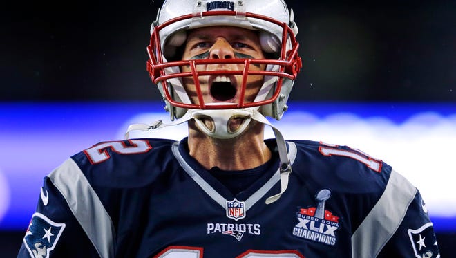New England Patriots quarterback Tom Brady  yells as he takes the field before the first game of the 2015 season.