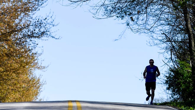 Training for the Boston Marathon, Henderson resident Paul Brantley tops a hill on Marywood Drive during his daily run Friday, April 7, 2017.
