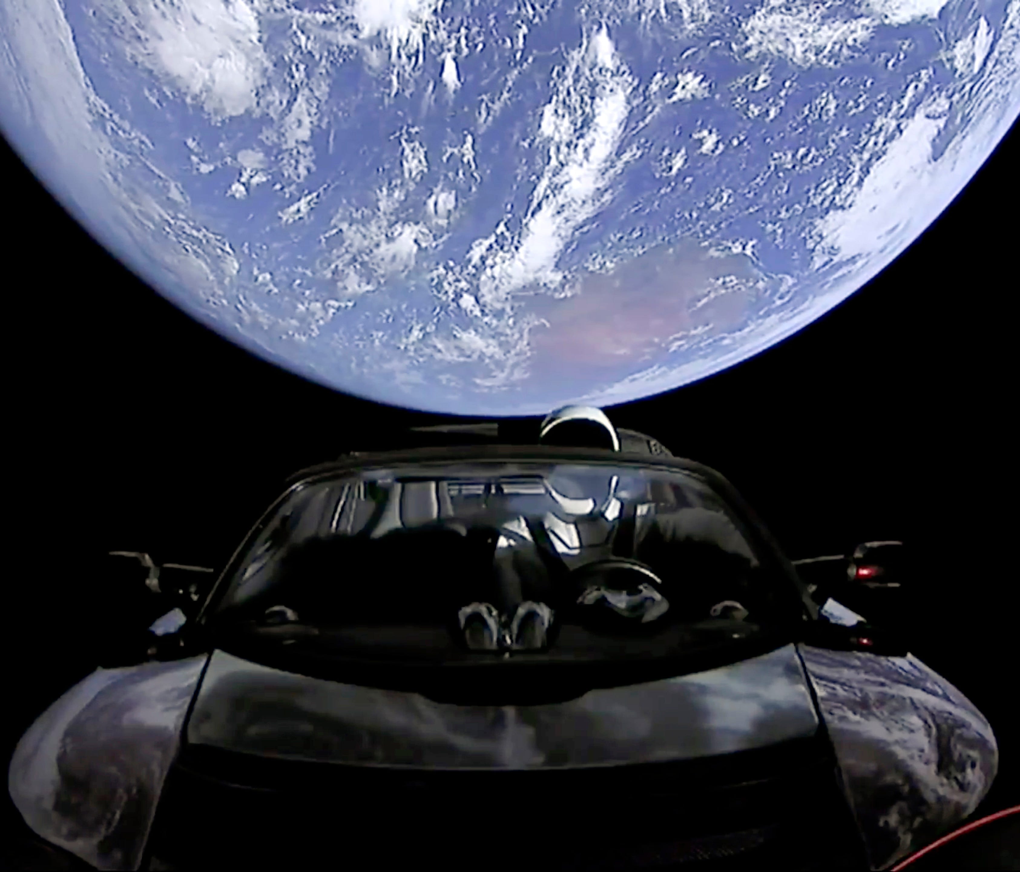 This image from video provided by SpaceX shows the company's spacesuit in Elon Musk's red Tesla sports car which was launched into space.