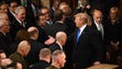 President Donald Trump shakes hands with members of