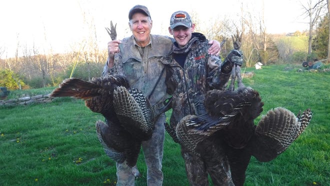 Josh Holland, 15, gets help from his grandfather Dick Pettit of Melbourne in showing the two turkey gobblers that Josh downed on recent consecutive daily hunts during spring turkey season in Kentucky. Josh, of Palm Bay, was hunting with his grandfather on Pettit's Family Homestead, a former tobacco farm in north-central Kentucky. The turkeys weighed 16 and 14 1/2 pounds.