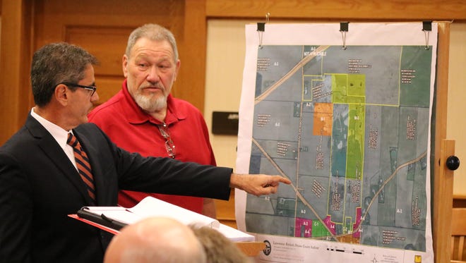 Attorney Robert Casarona and Benton Township zoning inspector Michael Reif point out where industrial work by Rocky Ridge Development LLC was witnessed at the former Stoneco quarry property.