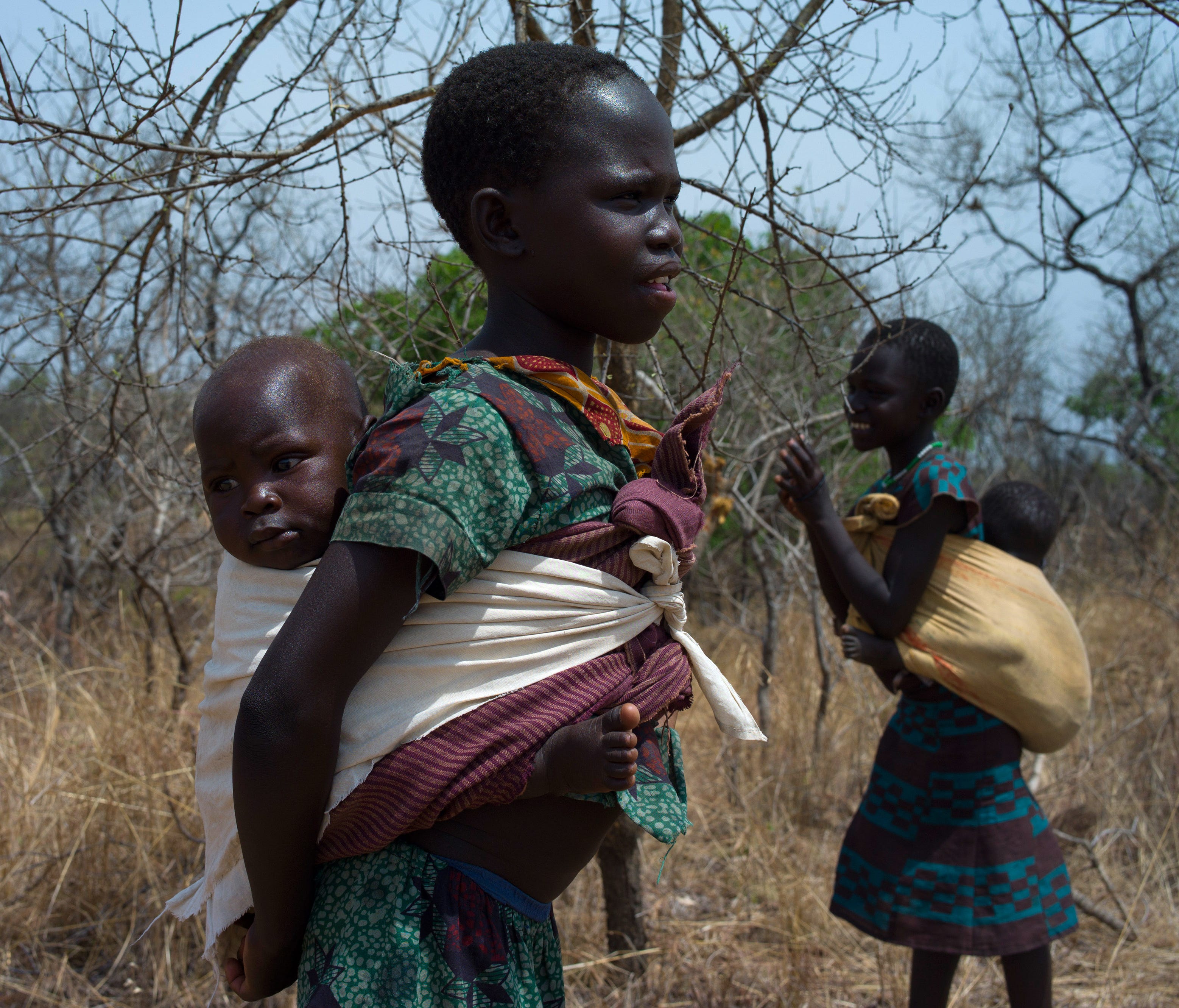 Children from South Sudan stand in scrub near the Bidi Bidi Refugee Camp in Uganda on Feb. 22, 2017.