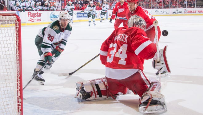 Minnesota right wing Jason Pominville tries to get the puck past Detroit goalie Petr Mrazek in the overtime period.