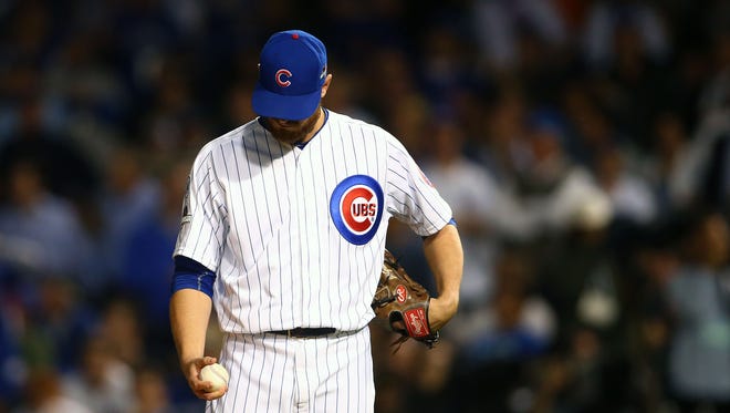 Cubs reliever Justin Grimm reacts after giving up a run in the seventh inning.