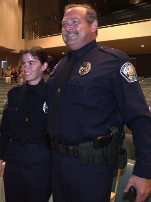 Palm Bay police Officer Rick Woronka hugs his daughter, C.J. Woronka, at her graduation in 2002 at the King Center for the Performing Arts in Melbourne. C.J. Woronka has served in the same department with her father.