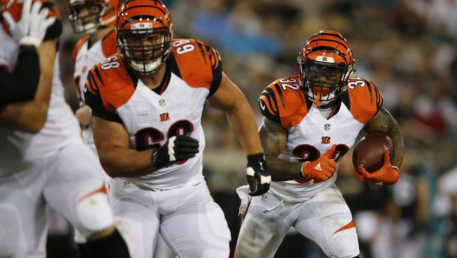 Former Cincinnati Bengals guard Kevin Zeitler, left, will now lead running backs for the Cleveland Browns.