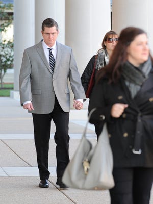 Dover Police officer Cpl. Thomas Webster, with his wife Suzanne walk to the Kent County Courthouse on Friday morning for closing arguments in the second-degree assault trial against Webster.