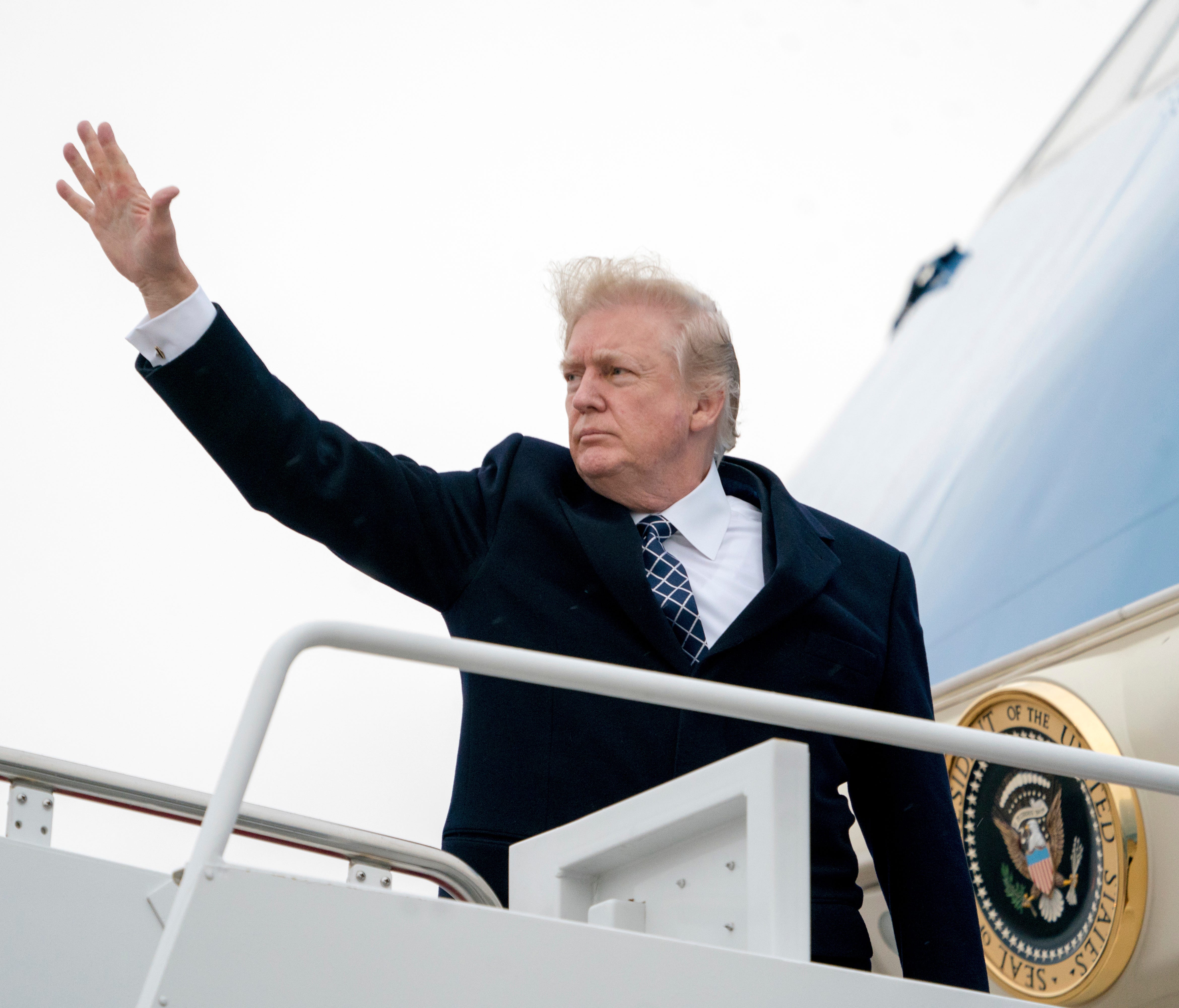 President Trump waves as he boards Air Force One at Andrews Air Force Base, Md., Friday, Jan. 12, 2018, to travel to Palm Beach International Airport in West Palm Beach, Fla.
