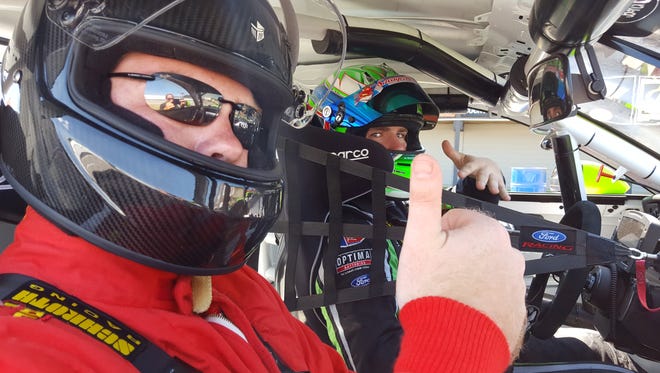 Mansfield News Journal reporter Connor Casey and Pirelli World Challenge driver Nate Stacy pose before a spin at the Mid-Ohio Sports Car Course on Wednesday.