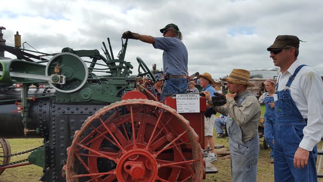 Onlookers and hobbyists prepare for a threshing demonstration with a 1909 steam engine at the North Central Wisconsin Antique & Gas Engine Show near Edgar on Aug. 28.