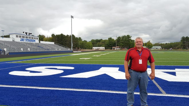 Building and Grounds Supervisor Dale Bergman poses for a photo on the new artificial turf at Merrill High School's renovated Jay Stadium on Sept. 7, 2016.