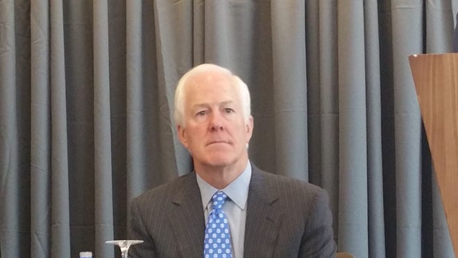 U.S. Sen. John Cornyn on Friday questioned President Trump's proposals for a 20 percent import tax and a wall all along the U.S.-Mexico border.