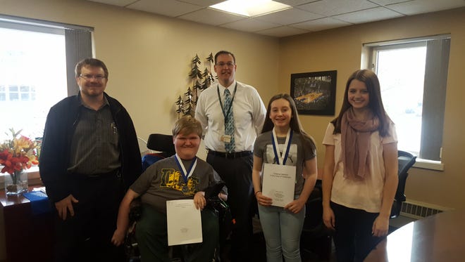 D.C. Everest Junior High School students who won medals for their essays, pictured with Everest Area Optimist Club President Shannon Dalton, from left, were Roy Thorson, silver, with Principal Jason McFarlane, Audrey Seibel, silver, and Kate Boersma, gold.