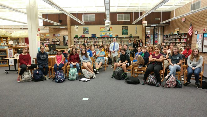 Daddy Duty columnist and FLORIDA TODAY editor Tim Walters stands among more than 70 students that he spoke to as part of Literacy Week. Walters spoke to six assembly groups at the library at DeLaura Middle School in Satellite Beach.