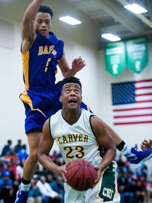 Carver's Xavious Turner (23) is defended by Daphne's Deontaye Buskey (5) in subregional action at Carver High School in Montgomery, Ala. on Tuesday February 16, 2016.