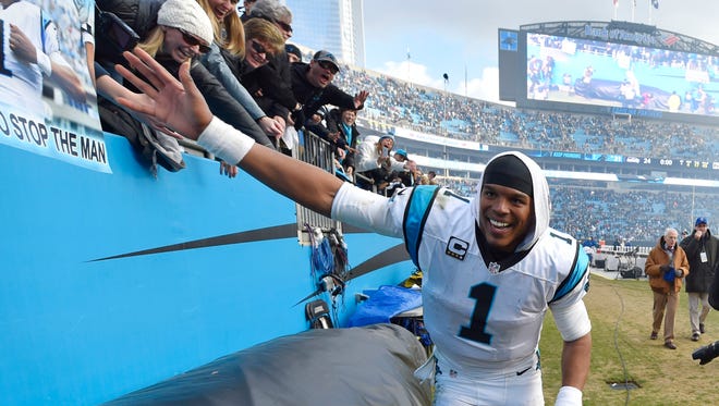 Jan 17, 2016; Charlotte, NC, USA; Carolina Panthers quarterback Cam Newton (1) celebrates with fans following their 31-24 defeat of the Seattle Seahawks in the NFC Divisional round playoff game at Bank of America Stadium. Mandatory Credit: Bob Donnan-USA TODAY Sports