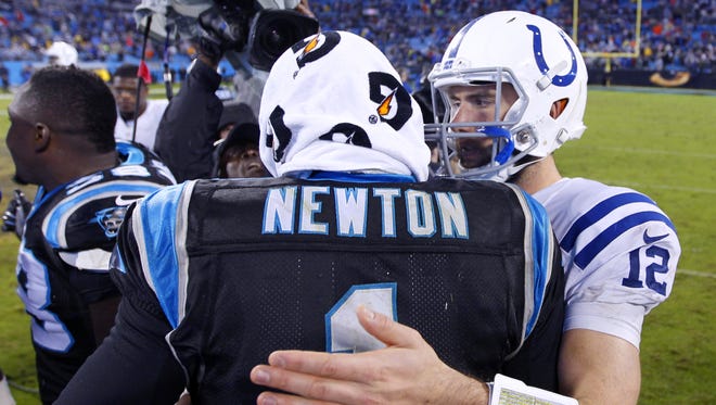 Indianapolis Colts quarterback Andrew Luck (12) meets with Carolina Panthers quarterback Cam Newton (1) after the team's loss of an NFL football game Monday, Nov. 2, 2015, at Bank of America Stadium in Charlotte, North Carolina. Panthers won in sudden-death overtime 29-26.