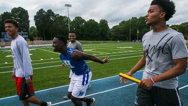 April 26, 2017 - (Left to right) - Charles Nichols, 17, laughs as Nick Martin, 18, clowns around as they walk with Austin Jackson, 16, and Calvin Austin III, 18, at Harding Academy on Wednesday. The young men are members of Harding Academy's 800 relay team and currently boast the top time in the state and one of the better times in the nation at 1:27.16.