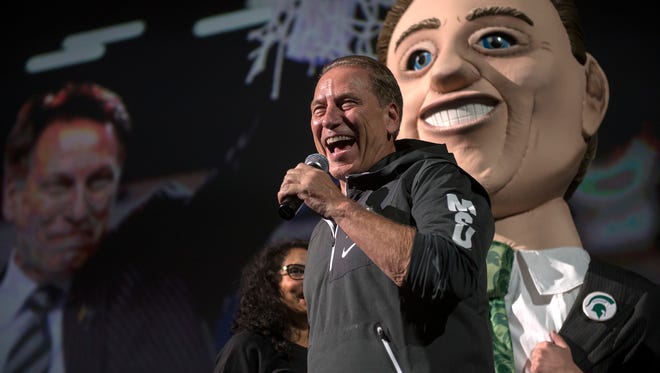 Michigan State University head coach Tom Izzo speaks to the crowd as a bobble-head version of himself stands in the background during the annual Midnight Madness event on Friday, Oct. 20, 2017, at the Breslin Center in East Lansing.