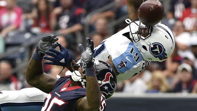 Texans cornerback Kareem Jackson (25) breaks up a pass intended for Titans wide receiver Tajae Sharpe (19) during the first half Sunday.