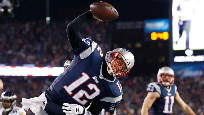 Patriots QB Tom Brady spikes the ball after his first-half TD run.