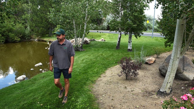 Landscape and maintenance superintendent Randy Lisenby walks through a common area at the Caughlin Ranch development in Reno on July 14, 2015.