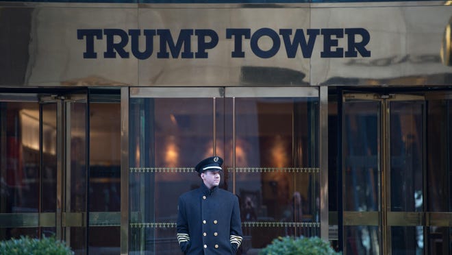 A doorman stands in front of Trump Tower in New York.