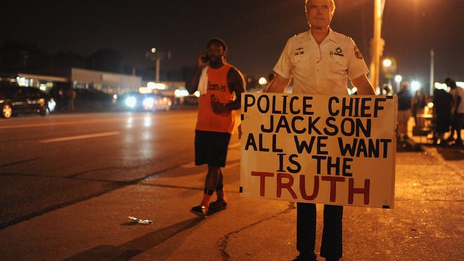
Retired Capt. Ray Lewis of the Philadelphia Police Department participates in a peaceful protest in Ferguson, Mo, on Saturday. 

