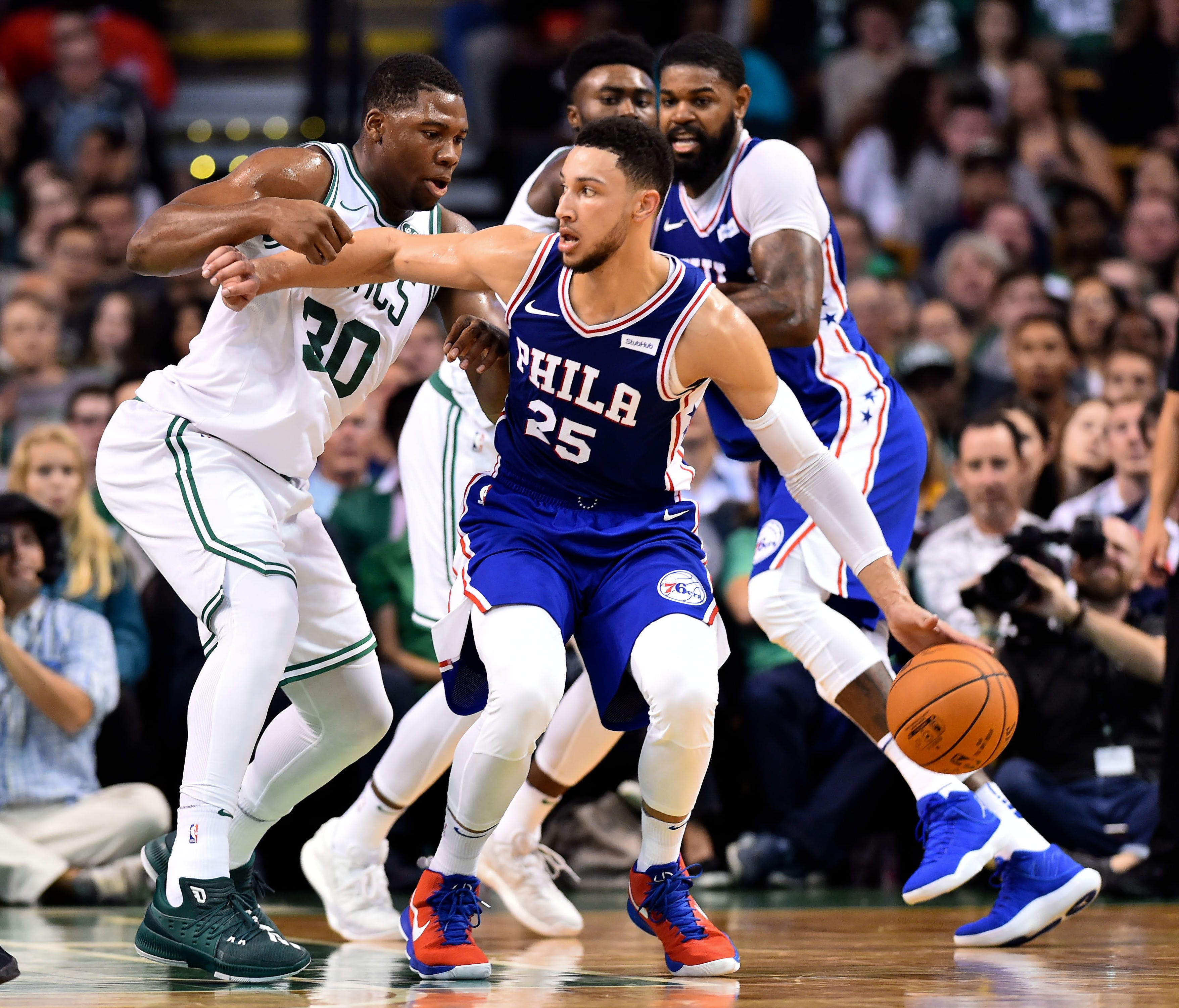 Philadelphia 76ers guard Ben Simmons (25) dribbles to the basket and is defended by Boston Celtics forward Guerschon Yabusele (30) during the first half at the TD Garden.