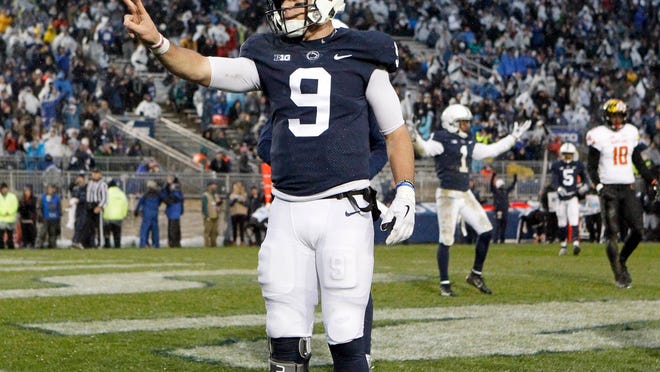 Penn State quarterback Trace McSorley (9) reacts after scoring his second rushing touchdown against Maryland during the first half of an NCAA college football game in State College, Pa., Saturday, Nov. 24, 2018. (AP Photo/Chris Knight)