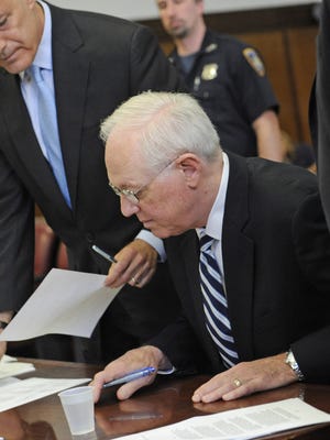 Former New York Comptroller Alan Hevesi, center, is arraigned in state Supreme Court in Manhattan in 2010. Despite a felony conviction, Hevesi receives a yearly state pension.